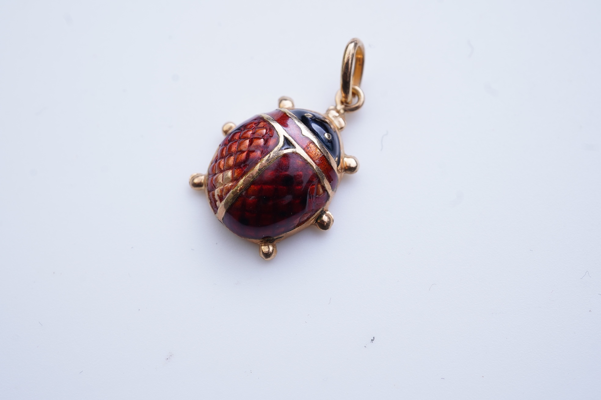 A gold and enamel pendant, Italy, 1960s